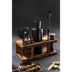 an assortment of kitchen utensils on a wooden stand