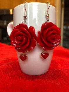 24mm polyresin red rose beads with dangling little 8mm red heart charms. 2 inches in length. If you want to spice up that outfit with a bright pair of red earrings these are for you. The perfect Holiday, Valentines Day, Mothers Day, or Birthday gift.❤️🌹 Cheap Rose-colored Jewelry For Valentine's Day, Cheap Rose Jewelry For Valentine's Day, Cheap Heart Pendant Earrings For Valentine's Day, Cheap Valentine's Day Jewelry With Flower Charm, Cheap Hoop Earrings For Valentine's Day Party, Cheap Rhinestone Jewelry For Valentine's Day, Cheap Bohemian Valentine's Day Earrings, Unique Cheap Red Earrings, Cheap Playful Red Jewelry