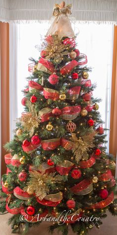 a decorated christmas tree with red and gold ornaments