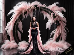 a woman is standing in front of a pink and black backdrop with feathers on it