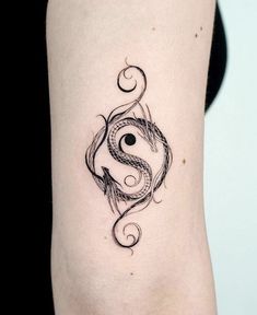 a woman's arm with a tattoo design on it, and an yin - yang symbol