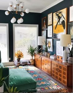 a living room filled with furniture and pictures on the wall