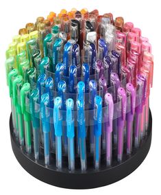 an assortment of different colored pens in a holder