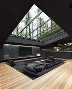 a large living room with wood floors and skylights