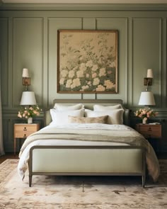 a large bed sitting in a bedroom next to two lamps and a painting on the wall