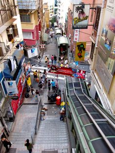 an overhead view of a city street with people walking on the sidewalk and buildings in the background