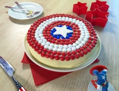 the cake is decorated with red, white and blue icing on top of it