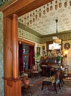 an ornately decorated living room with antique furniture and decor on the walls, along with a piano