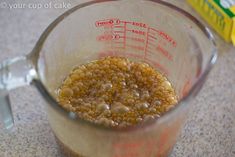 a measuring cup filled with food on top of a counter