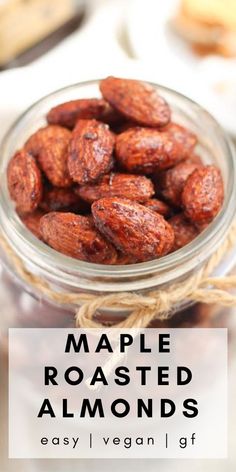 a glass jar filled with roasted almonds on top of a table