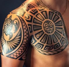 a close up of a man's chest and arm with tattoos on his body