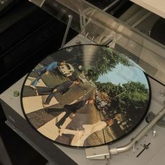 a record player with the image of the beatles on it's cover is shown