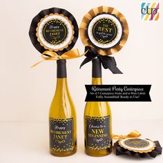 two wine bottles with award ribbons on them