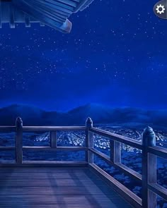 a balcony with a night sky and mountains in the background