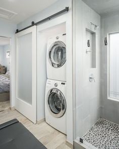 a washer and dryer in a bathroom next to each other with the door open