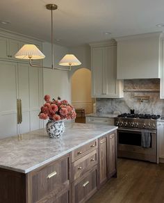 a large kitchen with an island, stove and sink in it's center area