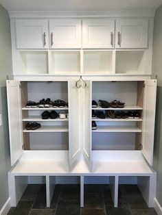 an open closet with shoes on the shelves