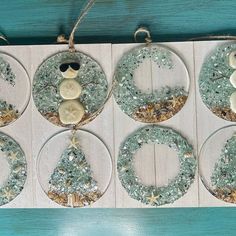 six glass ornaments with buttons and snow flakes