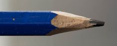 a blue pencil with a brown tip sticking out of it