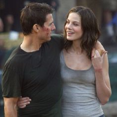 a man and woman standing next to each other on the street with blood all over their face