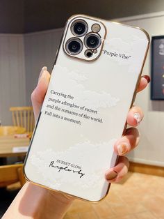 a person holding up a phone case with a quote on the back in front of them