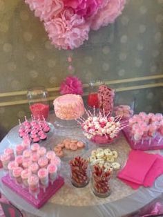 a table topped with lots of cupcakes and candy