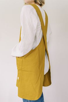 Our canvas crossback apron is ready for your garden, kitchen, workshop, and everything in between. Are you a coffee shop or bakery looking for custom aprons? We're here for you, contact us today! Handmade in Thailand by women seeking refuge and healing from trafficking + abuse. YOUR purchase directly supports this small team of 8 women. Read more 28.5" drop neckline to center front Canvas/Hemp Blend Made in Thailand Care: wash & dry normal *slight shrinking may occur Crossback Apron, Japanese Style Apron, Kitchen Workshop, Florist Tools, Shop Apron, Custom Aprons, Candle Tray, Garden Kitchen, Vintage Wall Decor