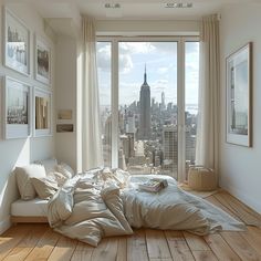 an unmade bed is in front of a large window overlooking the cityscape