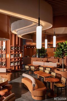 the interior of a restaurant with tables, chairs and bookshelves filled with books