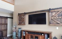 Special walnut Wall-mounted TV concealed with the wooden barn doors from the TV Hide package Barn Door Shutters, Bar Tv, Outdoor Tv Covers, Barn Door Cabinet, Barn Door Installation, Sliding Shutters, Hidden Tv, Tv Covers, Barn Door Track