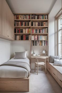 a bedroom with a bed, desk and bookshelf