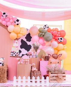 a cow themed birthday party with balloons and decorations