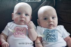 two babies are sitting next to each other on the same page, and one is holding a sign that says get one free