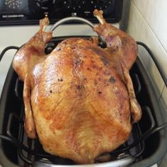 a whole chicken sitting on top of an oven