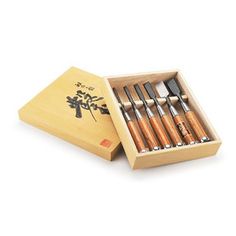 a wooden box with six knives in it