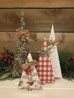 three small christmas trees with bows on them