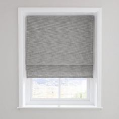 a grey roman blind in a bedroom