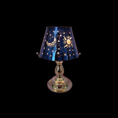 a lamp that is sitting on top of a glass base with a blue and gold shade