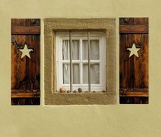 two windows with bars and stars on them