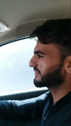 a man sitting in the passenger seat of a car