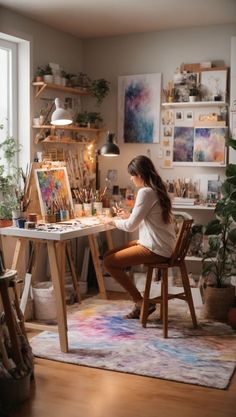 a woman sitting at a desk in front of an easel filled with art supplies