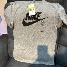 Tag Still In Brand New Never Used Nike Gray Tops With Letter Print, Nike Gray Tops With Logo Print, Nike Gray Top With Logo Print, Nike Gray Crew Neck Shirt, Nike Gray Short Sleeve Shirt, Nike Gray Cotton Tops, Basic Gray Top With Logo Print, Gray Logo Print Casual Shirt, Gray Casual Shirt With Logo Print