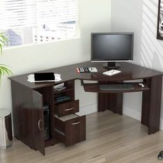 a computer desk with a monitor and keyboard