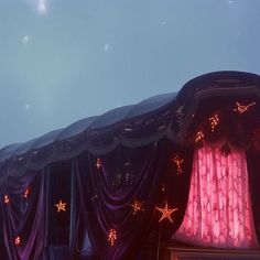 a stage with curtains and stars on it