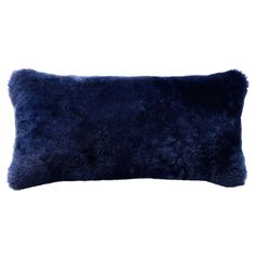 a dark blue pillow on a white background