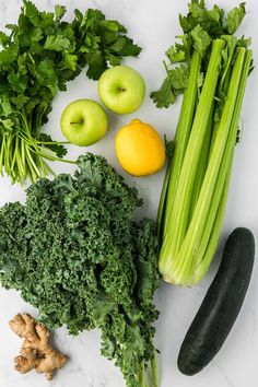 green vegetables and fruits on a white counter top