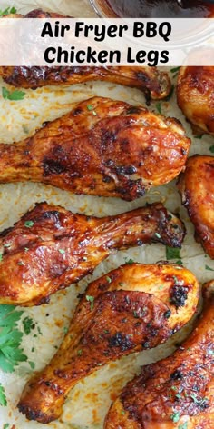 grilled chicken legs on parchment paper with sauce and parsley in the background text reads air fryer bbq chicken legs