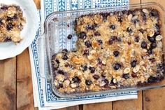 a blueberry crumbled dessert sitting on top of a wooden table