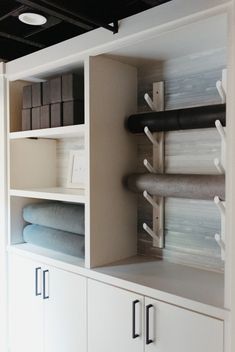 the shelves in this room are filled with towels and other things to put on them