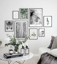 a living room with pictures on the wall and a coffee table in front of it